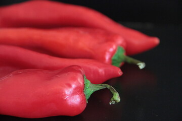 colorful peppers on a black background
