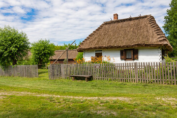 Fototapeta na wymiar Traditional village in Poland. Open Air Museum. Wooden houses. Wooden folk architecture from different areas of the Lublin Voivodeship. Poland