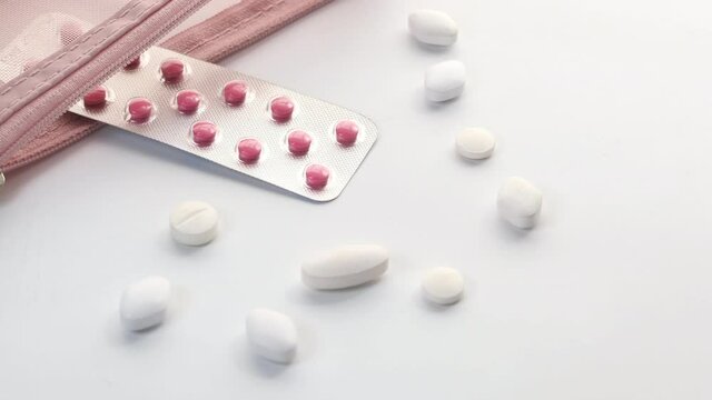  white pills and blister pack on white background 