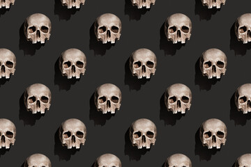 Old human skull with shadow on black background abstract pattern