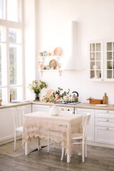 Fototapeta na wymiar Light modern kitchen in cozy house.