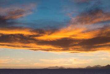Fototapeta na wymiar Fiery Sunset At Salar De Uyuni, Bolivia