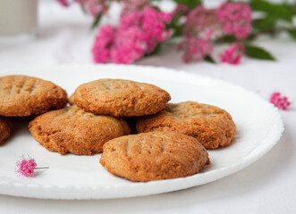 homemade peanut cookies with pink flowers on the white background