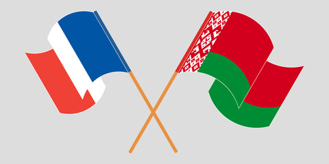 Crossed and waving flags of Belarus and France