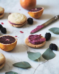 Open faced blackberry blood orange cookie sandwich with frosting