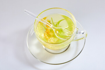 Transparent glass cup of tea with linden isolated on white