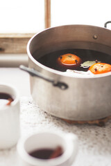 Vintage rustic modern scene mulled wine in pot with mugs