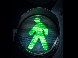 traffic light with a green man on a black background