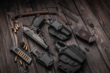 the gun and holster lay on a wooden Board