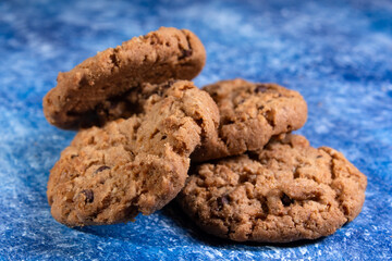 Oatmeal cookies on a blue colored background, healthy diet food