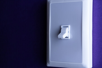 White switch on blue background in the lower position