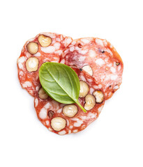 Sliced italian salami with hazelnuts and basil leaf