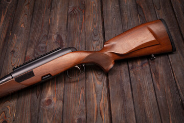 bolt action rifle on a wooden shield