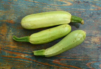fresh green zucchini on a wooden table.