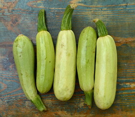 fresh green zucchini on a wooden table.
