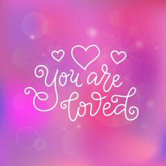 Modern calligraphy lettering of You are loved in white on pink background with stars and hearts