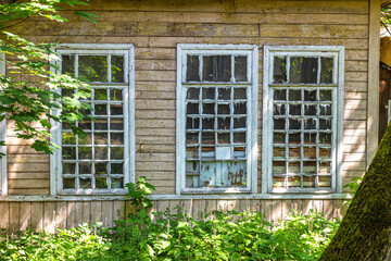 An old wooden house with peeling paint on the walls and window frames