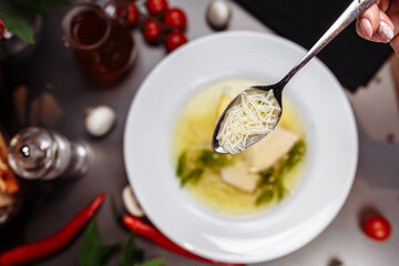 a white bowl filled with Delicious chicken noodle soup