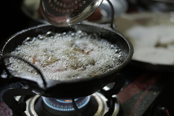 delicious food prepared in hot oil in a kitchen.