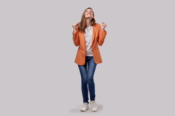 The joy of winning or winning. Happy girl smiles, laughs and raised her hands.