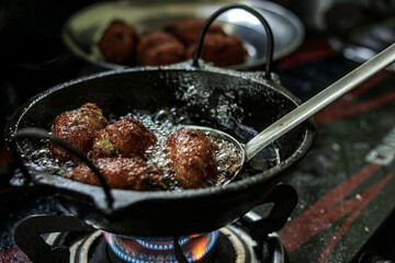 delicious food prepared in hot oil in a kitchen.