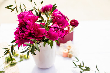 Fototapeta na wymiar Vase of pink peony on a white background