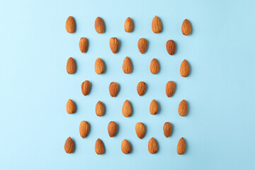 Flat lay with almond on blue background. Vitamin food