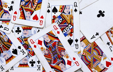 Pile of playing cards at a rustic wooden board.