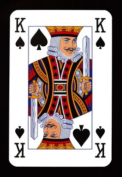 King of spades playing card isolated on black.