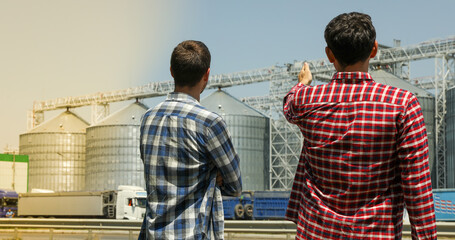 Two farmers against grain silos. Agriculture business © Atlas