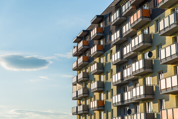 Exterior of modern residential apartment building with balconies on housing estate. Urban landscape...