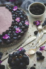 Homemade blackberry tart. Sweet pie with blackberrym blueberry and grapes on stone table