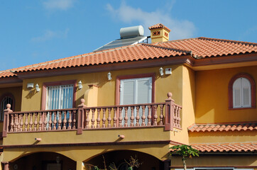 Modern Holiday Villa with Stone Balustrade  & Solar Panel against Blue Sky 