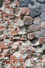 background old brick wall from the ruined castle, round blocks, red brick.