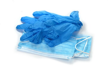A pair of thin blue medical latex gloves and face shield on a white background. Disposable rubber medical gloves and mask. Protective subjects. Remedies.