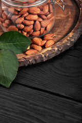 glass jar with almond on wooden board Vitamin food