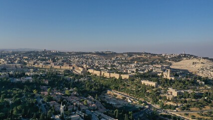 Fototapeta na wymiar The old city of Jerusalem walls at sunset, aerial view old city, Jerusalem, Montefiore Windmill,golden dome of the rock, drone 