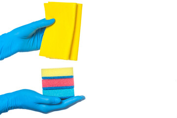 a hand in a blue glove holds multi-colored sponges and a yellow rag for cleaning rooms. on a white background.