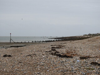 Stony breakwater beach on a cloudy day