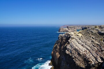 Fototapeta na wymiar Cliff at Cabo Sao Vicente on a sunny day, Algarve, Portugal