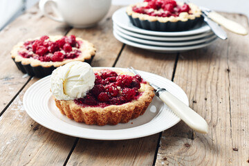 Baked mini tarts with raspberries.