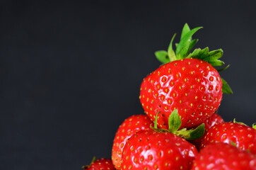 Strawberry red ripe sweet lined pile on top of one close-up on a grey background