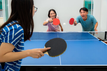 Couple fun playing table tennis or Ping pong indoor together leisure with competing in sports games...