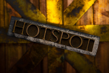Hotspot text formed with real authentic typeset letters on vintage textured silver grunge copper and gold background