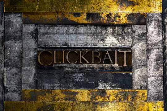 Clickbait text formed with real authentic typeset letters on vintage textured silver grunge copper and gold background