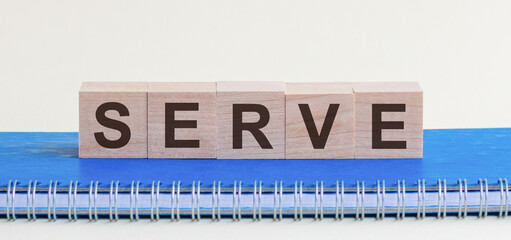 Serve - a word made of wooden blocks with black letters, a row of blocks is located on a blue...