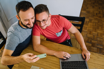 Two men taking a picture with his mobile phone.