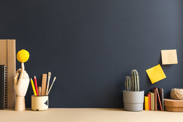 Desk, vintage style workspace with cactus and books.	