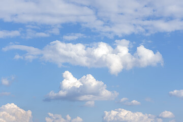 Naklejka na ściany i meble abstract background of white fluffy clouds on a bright blue sky