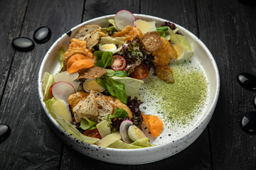 meat salad with vegetables, tomatoes, carrots on a white plate
